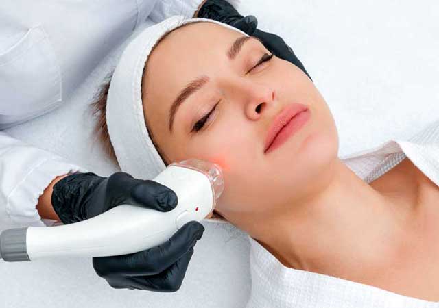 Woman getting laser skin treatment