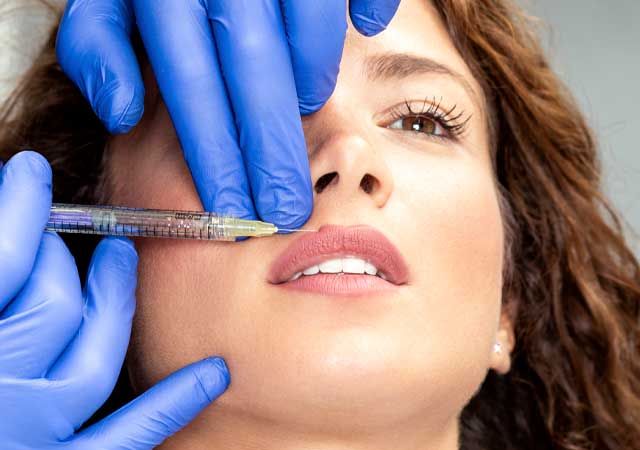 Woman getting lip injections/filler